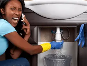 Emergency plumbing repair for a leaking sink drain under a bathroom vanity in Buffalo, NY