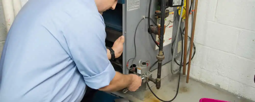 Furnace repair technician inspecting and servicing a home heating system in Buffalo, NY