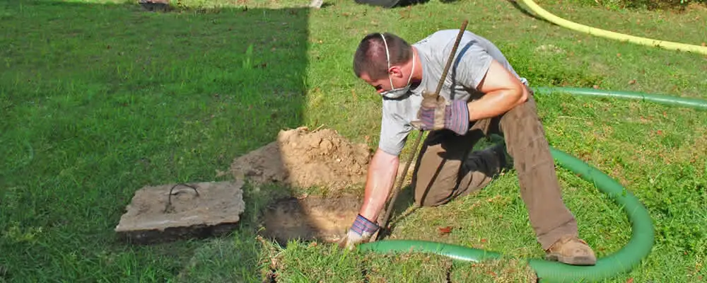 Septic pumping technician servicing a residential septic tank in Buffalo, NY